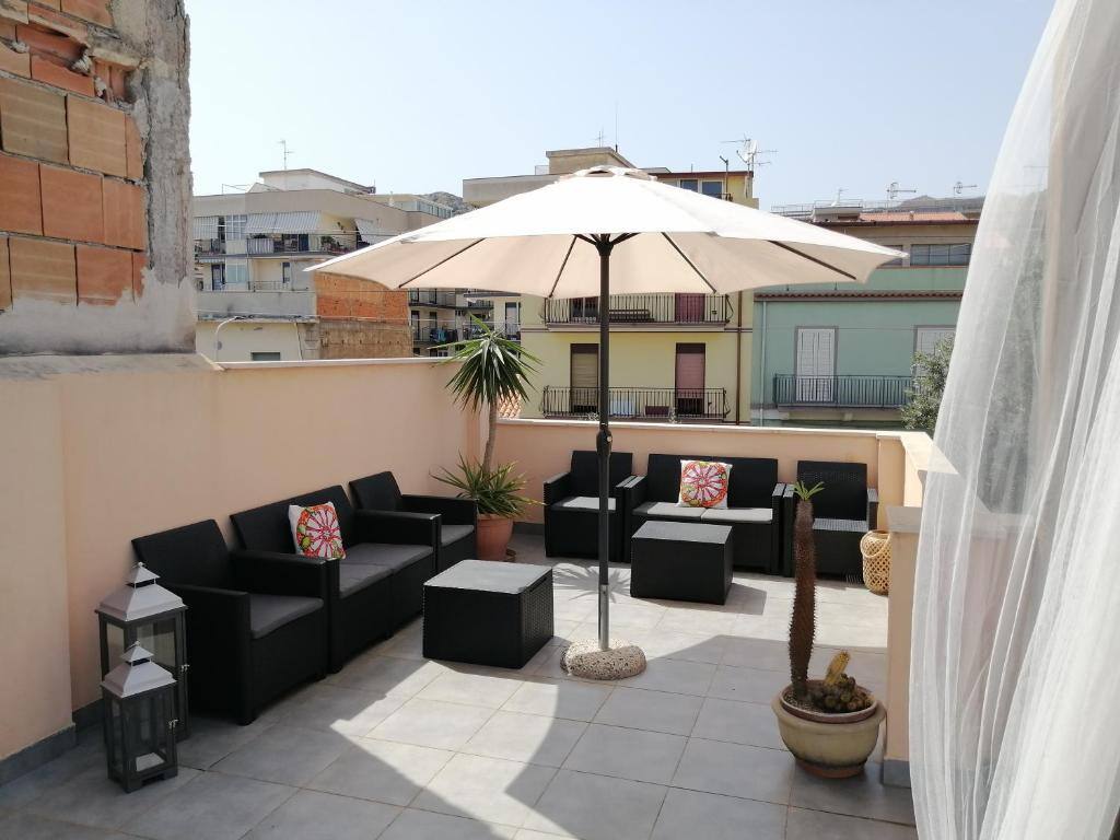Sun terrace with umbrella at b & b Jasmine